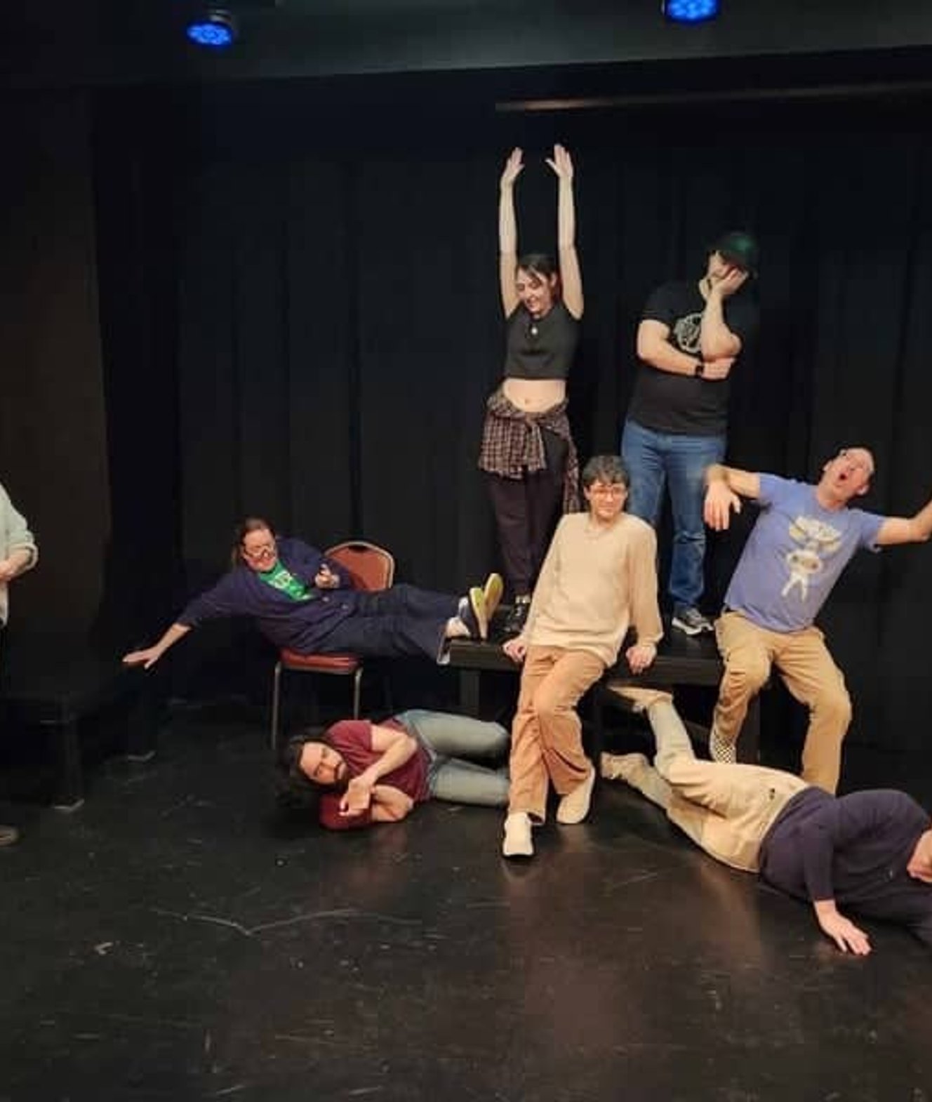 Performers acting on stage during improv scene