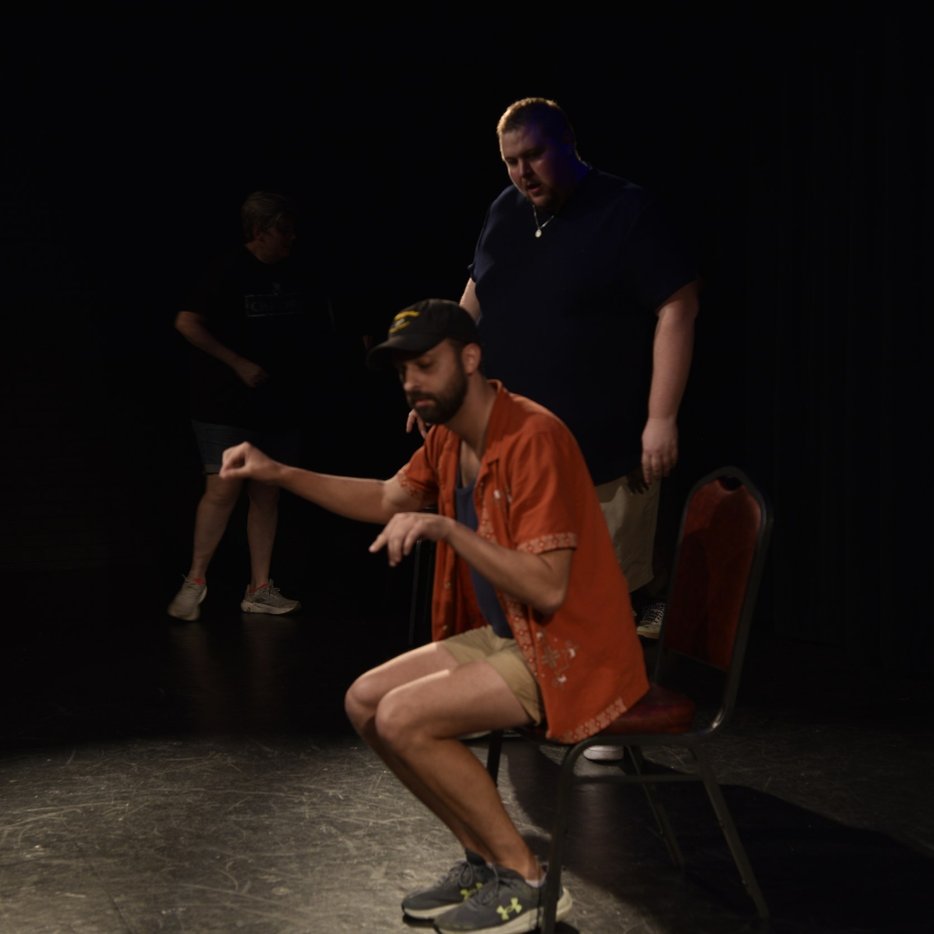 Improviser in an orange shirt on the YAIF 2026 stage