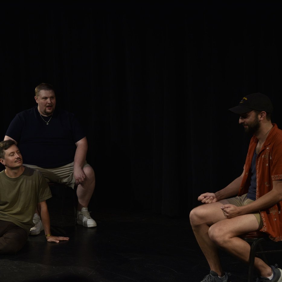 Two improvisers sharing a quiet moment on stage
