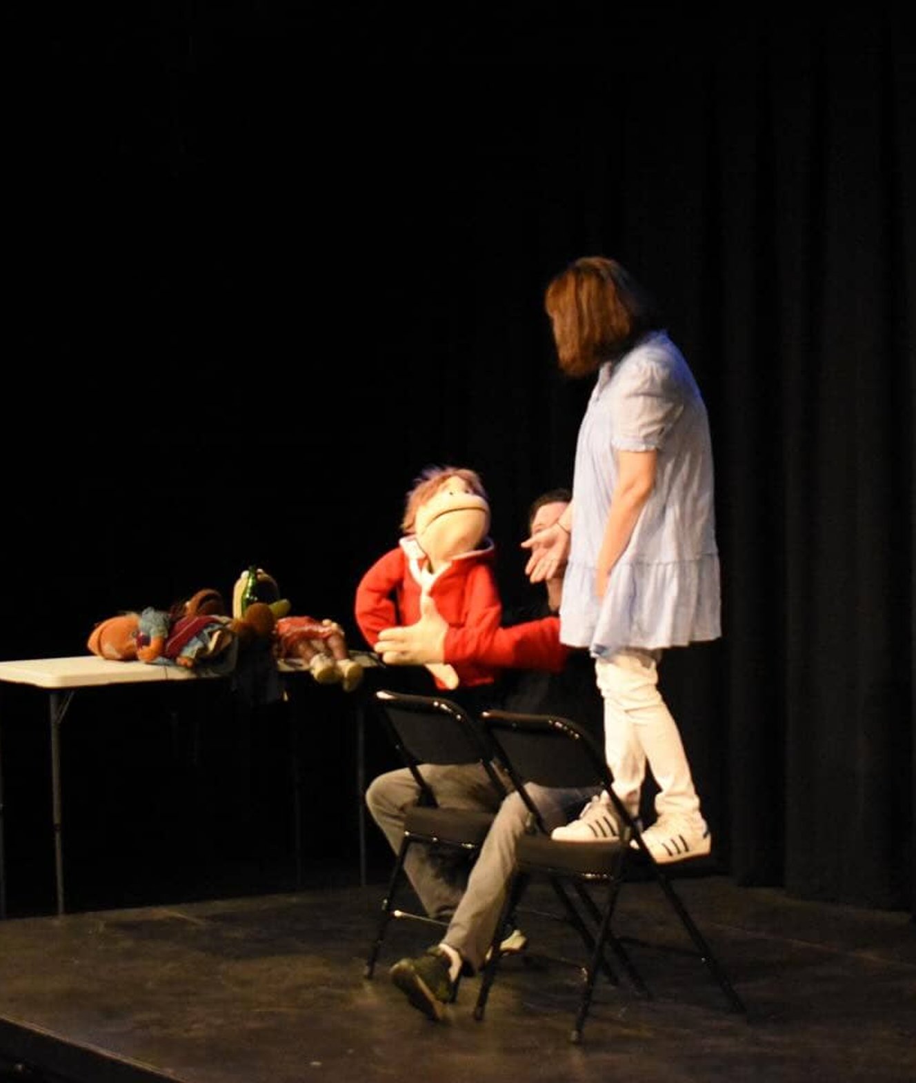 Performers acting on stage during improv scene