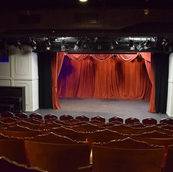 Theater interior with red stage curtain